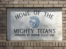 The marble sign in front of Woodham High School that reads, "Home of the Mighty Titans, Donated by Senior Class 1981"