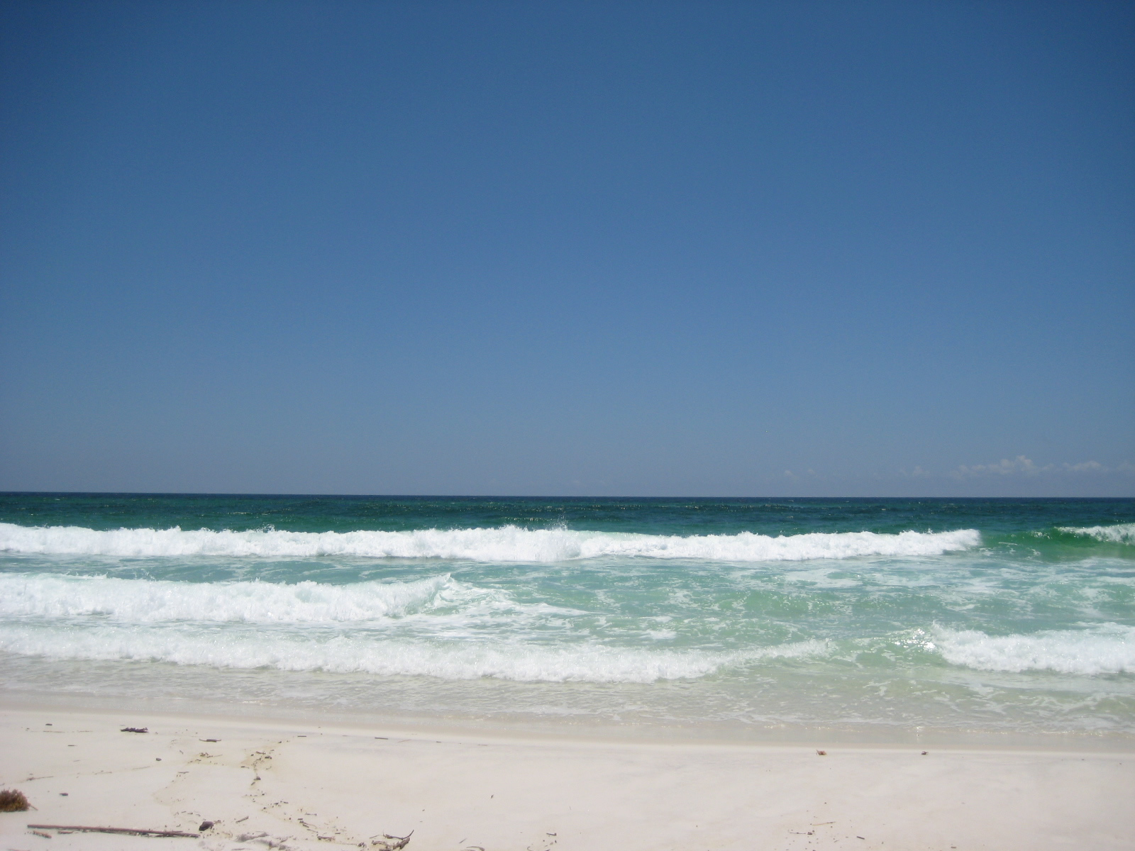 Pensacola Beach, with white sand and blue-green water.